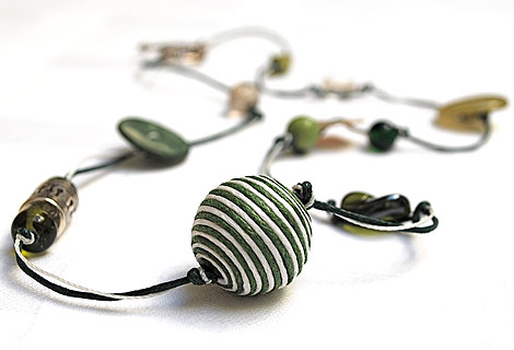 Caroline bead and button necklace - Stylish and eye-catching long necklace. Mixture of green and white beads and buttons of varying sizes. Strung and knotted with double thread and fastened with an ornate toggle bar and ring.