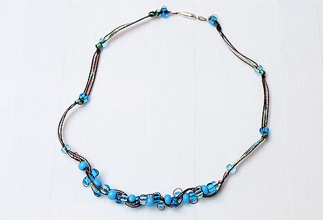 Joanne ribbon and wire threaded necklace - Beautiful combination of woven wire, iridescent maroon ribbon and blue beads make up this sparkling necklace. Fastened with a silver plated screw clasp. Matching bracelet and earrings available.