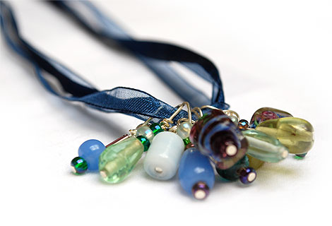 Amanda bead cluster pendant - Gorgeous cluster of blue, green and purple glass beads hanging from a necklace of three navy blue ribbons. Lobster clasp and chain.