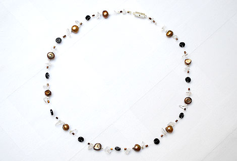 Nicola pearl floating necklace - This exquisite necklace of bronze freshwater pearls, semi-precious gems and disc-shaped black beads floats on your skin and adds a touch of glamour to any outfit. Strung onto clear illusion cord. Magnetic clasp.