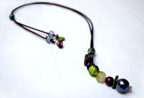 Harlequin burgundy/green long drop pendant - Funky and bright, this pendant is designed to be worn long, but can be adjusted in length using a sliding bead. Beautiful bright green and burgundy beads hang from a silky ribbon cord.