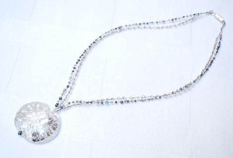 Glacier disc pendant - A beautiful glass pendant adorned with ‘cracked’ silver foil, hanging from a double length of ‘crinkle’ wire, threaded with silver, grey and clear seed beads. Magnetic clasp.